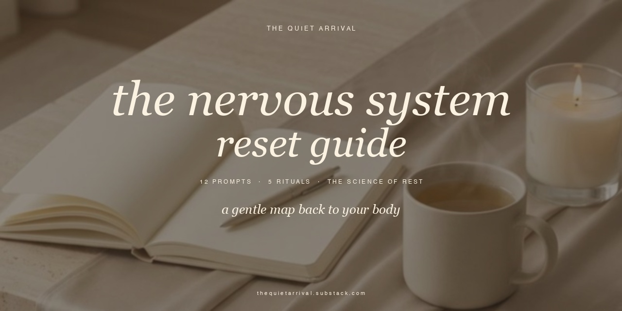 The Nervous System Reset Guide leaning on a travertine ledge, lamp and tea beside it